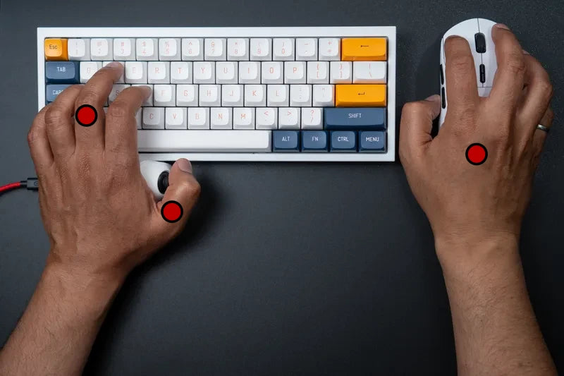 Left thumb on the MaxxStick joystick below the keyboard, fingers up on the keys, right hand on the mouse